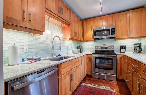 Twin Oaks House | Palm-surrounded abode with screened-in balcony, chef's kitchen, smart TVs, & W/D