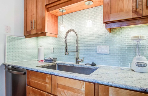 Twin Oaks House | Palm-surrounded abode with screened-in balcony, chef's kitchen, smart TVs, & W/D