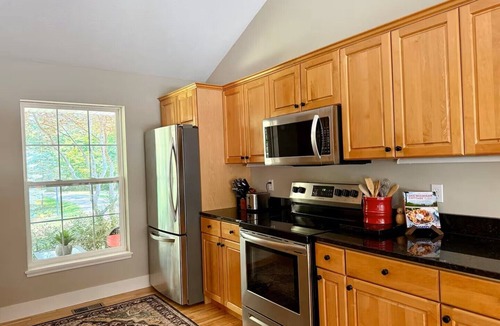 Fennville House | Upscale Wooded Retreat: Heated Pool, Hot tub, Fenced Yard & Game Room.