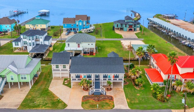 Modern waterfront home with boat lift, dock, game tables, kayak, & AC