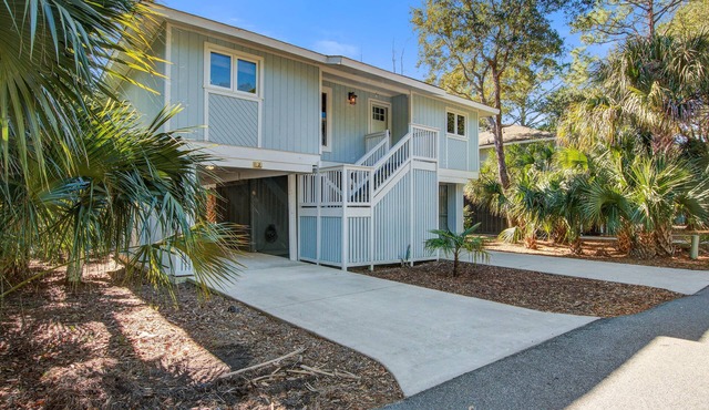 Palm-surrounded abode with screened-in balcony, chef's kitchen, smart TVs, & W/D