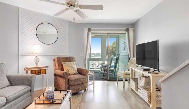 Second-floor villa w/river views & community pool, tennis courts, and dock
