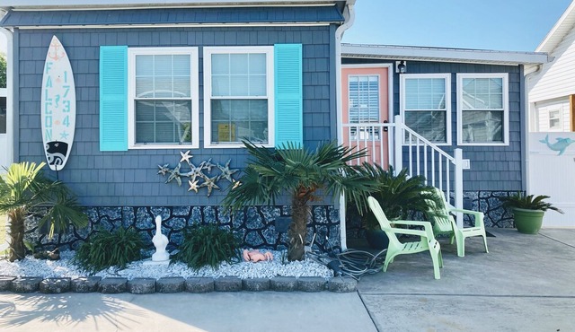 One minute drive to beach with golfcart! Newly updated, beach decor and clean!