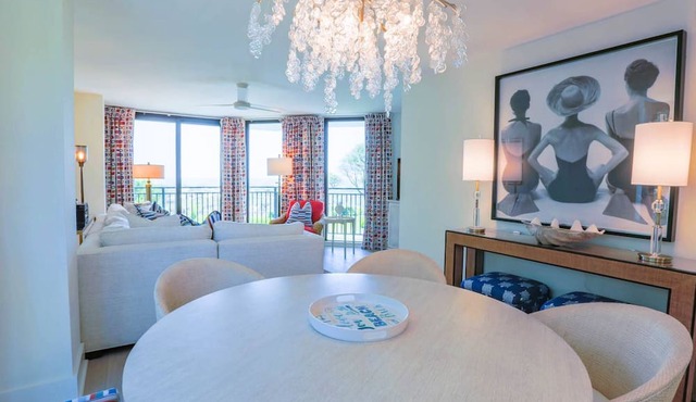 Professionally Decorated Corner Condo with Ocean Views, Covered Balcony & Access to Community Pool